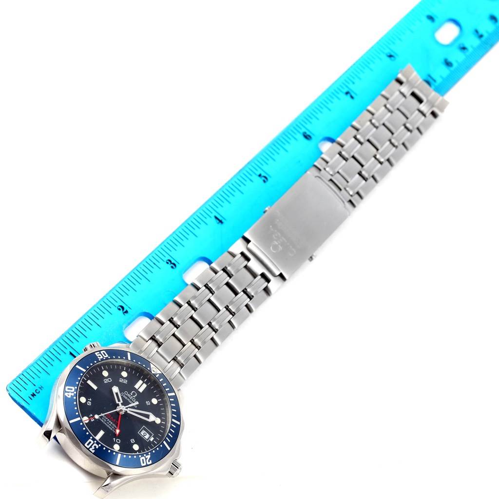 The Omega Seamaster 2535.80.00 Men
s Stainless Steel Blue Dial 2535.80.00 Men
s Stainless Steel Blue Dial watch is shown from a top-down angle, displaying the face, bezel, and stainless steel bracelet alongside a ruler.