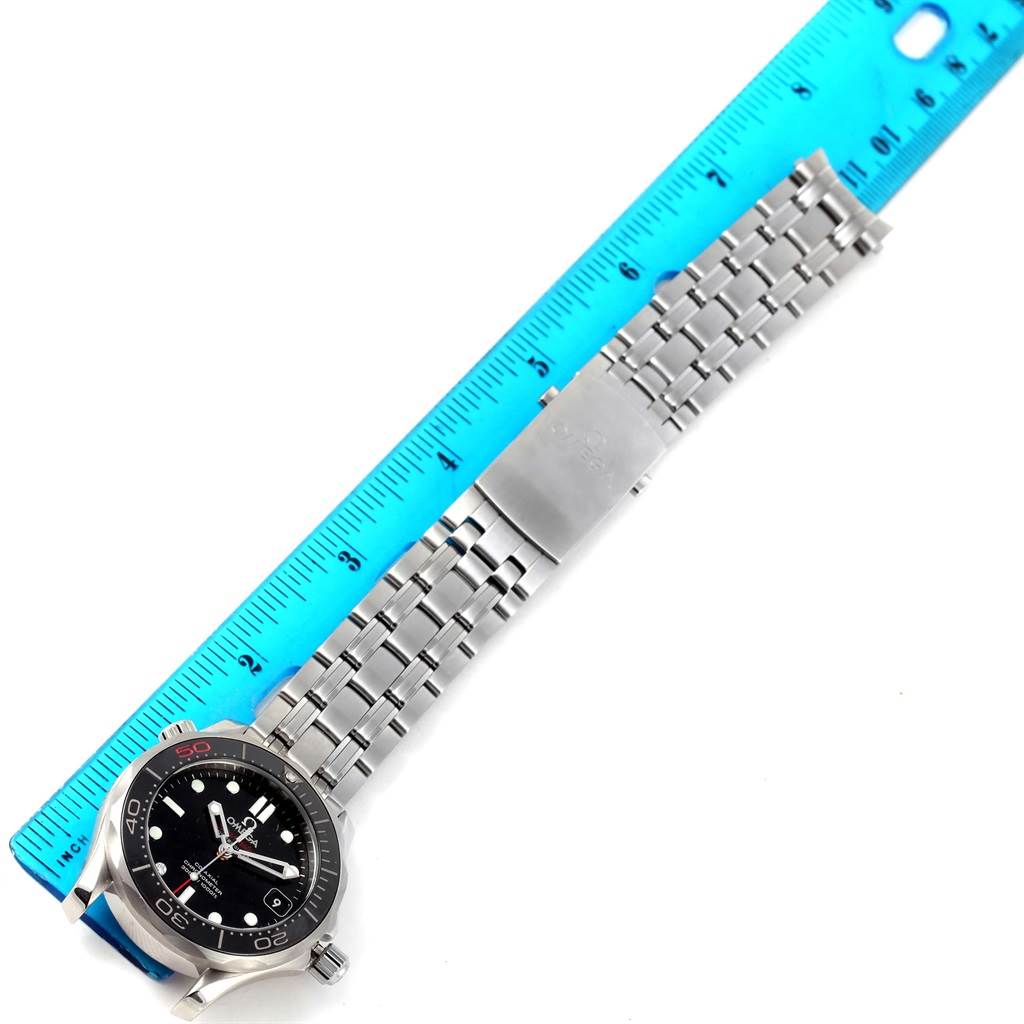 The image depicts the Omega Seamaster 212.30.36.20.51.001 Men
s Stainless Steel Black Dial 212.30.36.20.51.001 Men
s Stainless Steel Black Dial watch laid flat, showing its face, bezel, and metallic bracelet next to a blue ruler.