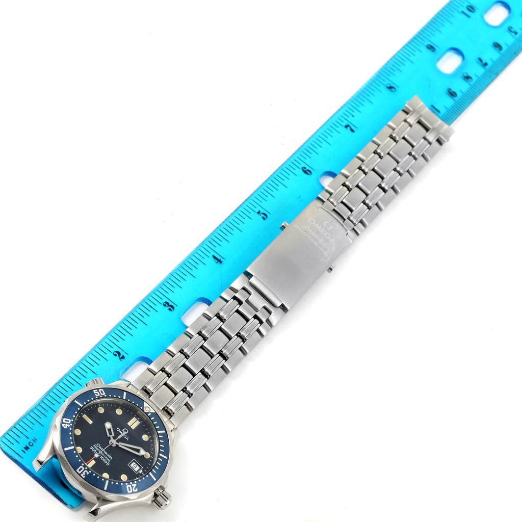 The image shows an Omega Seamaster 2561.80.00 Men
s Stainless Steel Blue Dial 2561.80.00 Men
s Stainless Steel Blue Dial watch laid flat next to a ruler, displaying its face and metal bracelet.