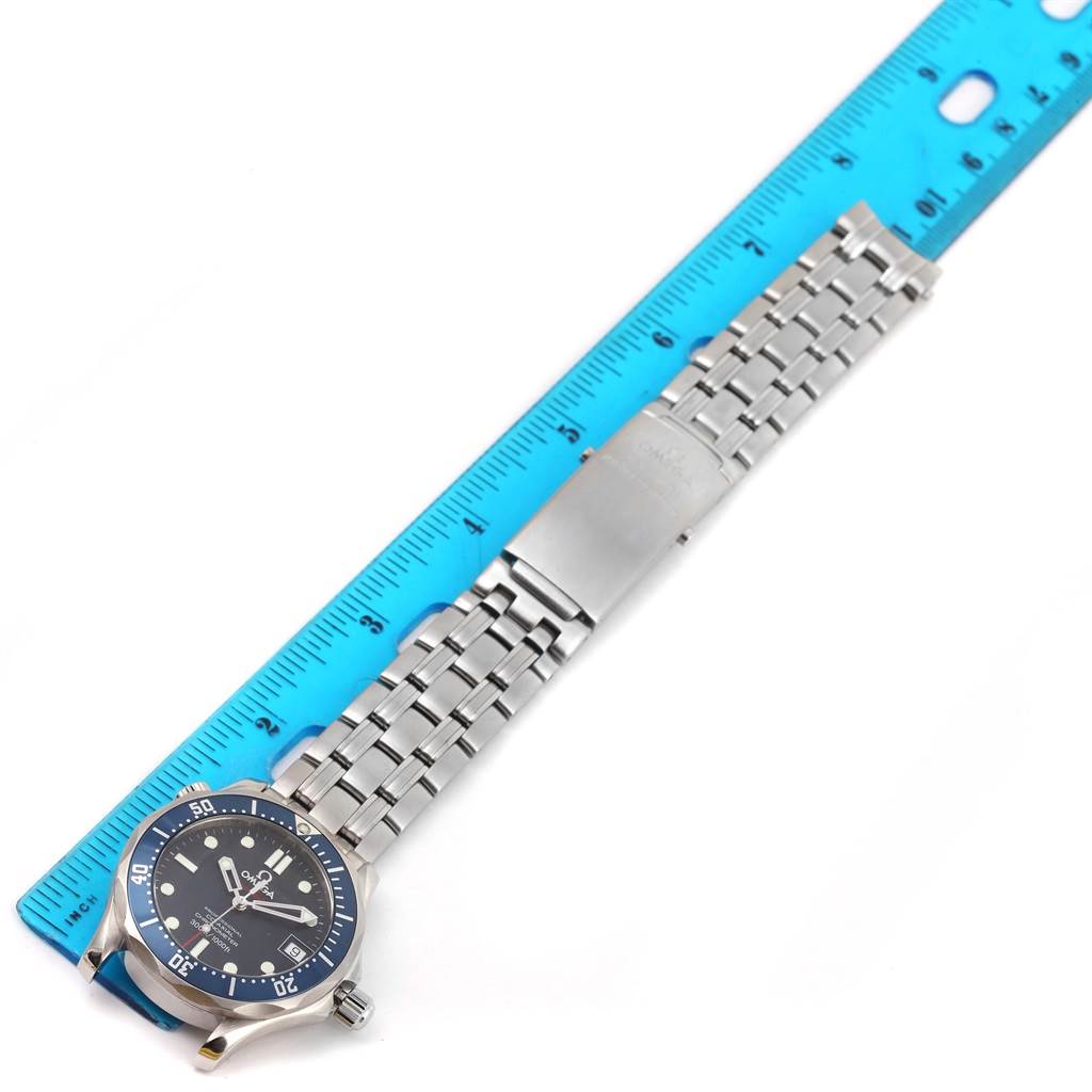 The image shows an Omega Seamaster 2222.80.00 Men
s Stainless Steel Blue Dial 2222.80.00 Men
s Stainless Steel Blue Dial watch laid flat next to a ruler, highlighting the face and metal bracelet from an overhead view.