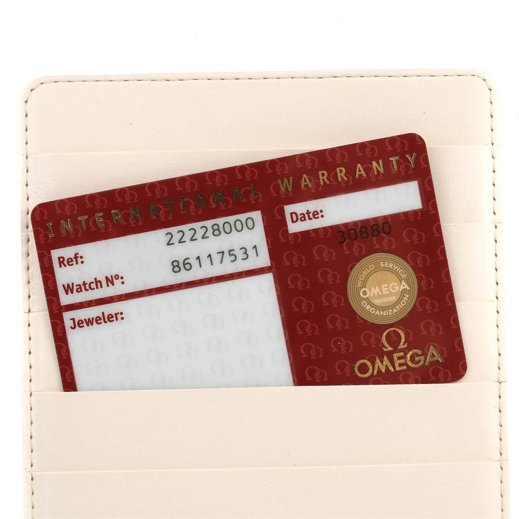 This image shows an Omega Seamaster 2222.80.00 Men's Stainless Steel Blue Dial 2222.80.00 Men's Stainless Steel Blue Dial international warranty card placed inside a cream-colored cardholder.