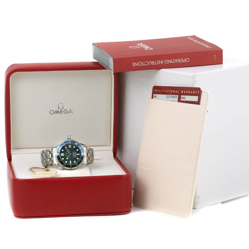 The image shows an Omega Seamaster 2222.80.00 Men's Stainless Steel Blue Dial 2222.80.00 Men's Stainless Steel Blue Dial watch in a red box, along with the instruction manual and international warranty card.