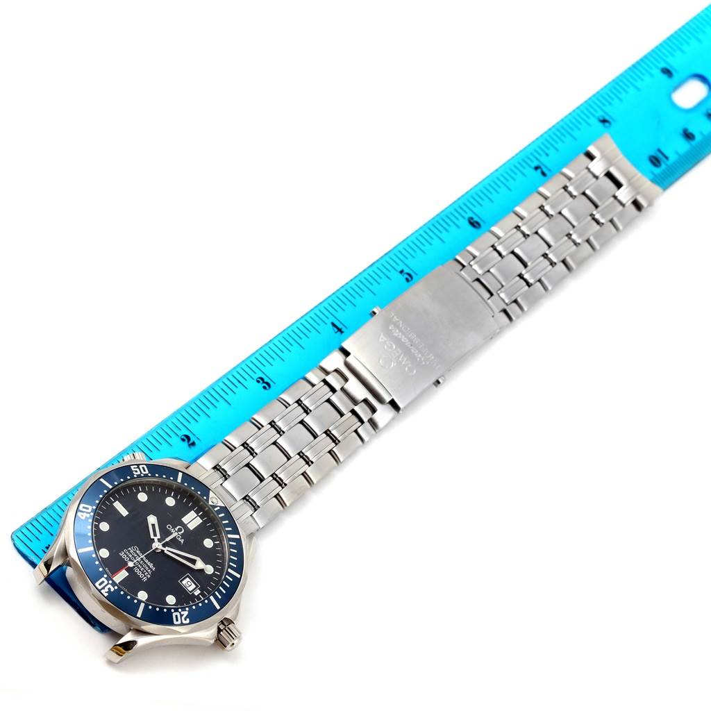 The image shows an Omega Seamaster 2531.80.00 Men
s Stainless Steel Blue Dial 2531.80.00 Men
s Stainless Steel Blue Dial watch laid flat with its dial, bracelet, and clasp visible, alongside a ruler for scale.