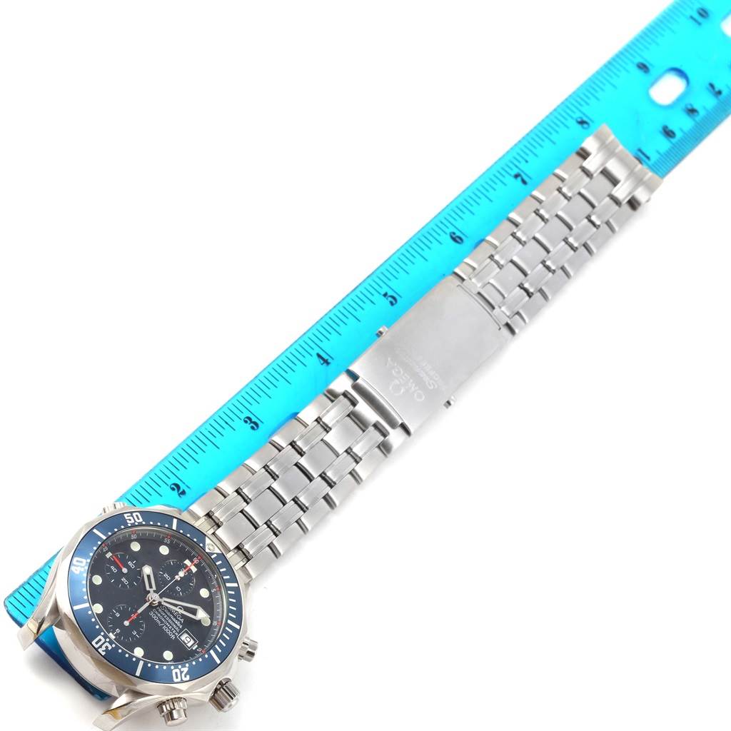 The image shows an Omega Seamaster 2599.80.00 Men
s Stainless Steel Blue Dial 2599.80.00 Men
s Stainless Steel Blue Dial watch with a blue dial and stainless steel bracelet, photographed straight-on next to a ruler.