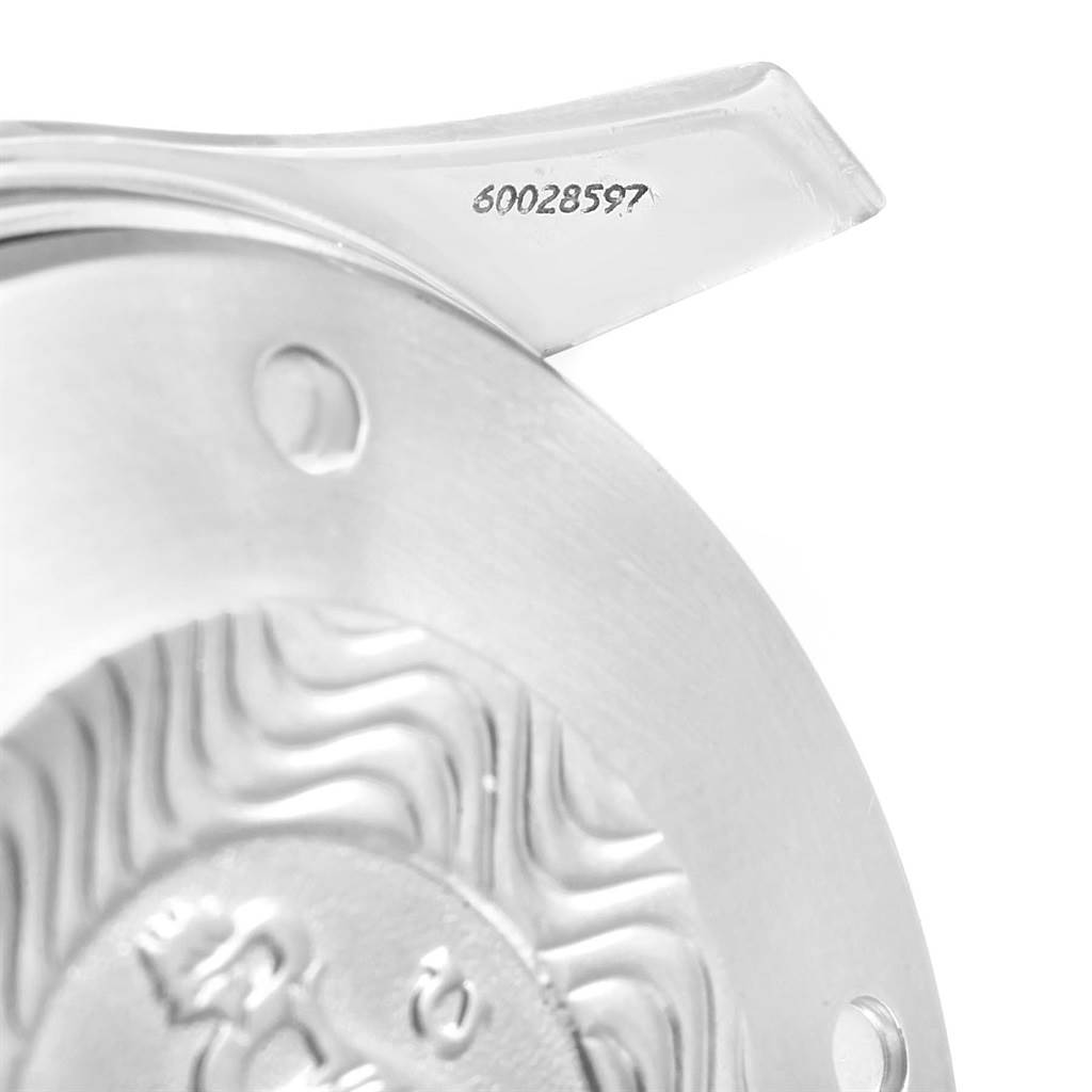 The image shows a close-up of an Omega Seamaster 2599.80.00 Men
s Stainless Steel Blue Dial 2599.80.00 Men
s Stainless Steel Blue Dial with focus on the serial number and back casing
s wave pattern.
