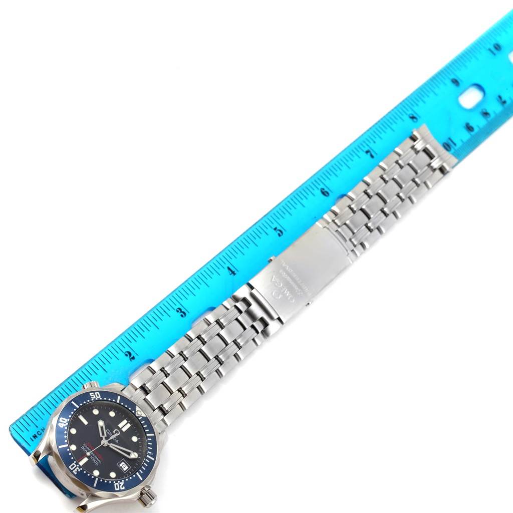 The image shows an Omega Seamaster 2223.80.00 Men's Stainless Steel Blue Dial 2223.80.00 Men's Stainless Steel Blue Dial watch and its stainless steel bracelet next to a ruler, from a top-down angle.