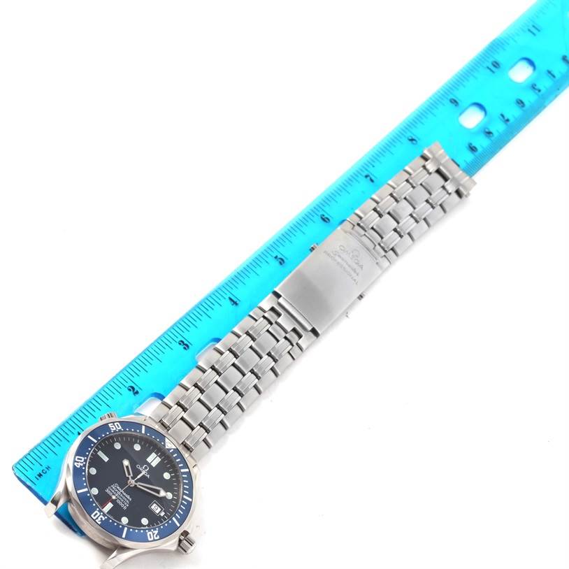 The image shows the Omega Seamaster 2531.80.00 Men
s Stainless Steel Blue Dial 2531.80.00 Men
s Stainless Steel Blue Dial watch laid flat next to a blue ruler, displaying its face, bezel, and metal bracelet.