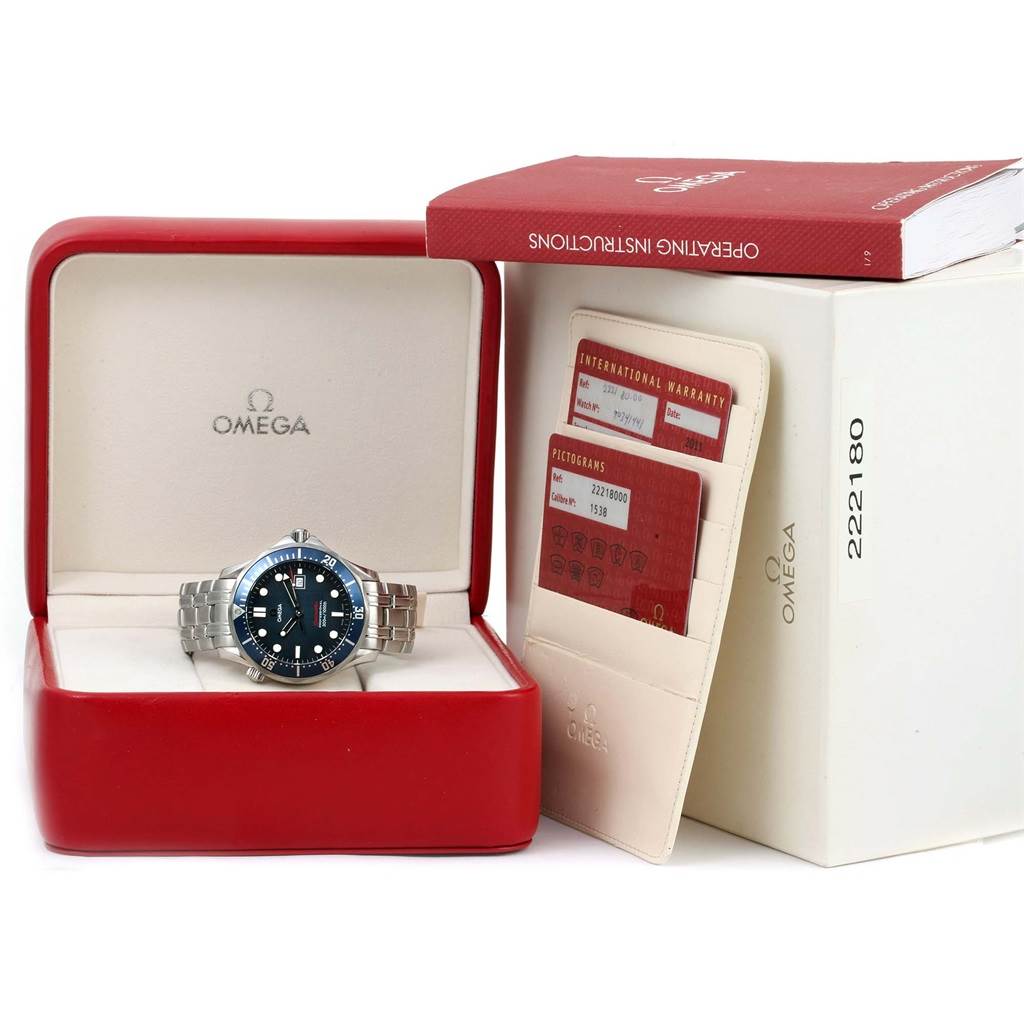 The Omega Seamaster 2221.80.00 Men
s Stainless Steel Blue Dial 2221.80.00 Men
s Stainless Steel Blue Dial watch is displayed front-facing in a red box with warranty cards, instruction booklet, and external box visible.