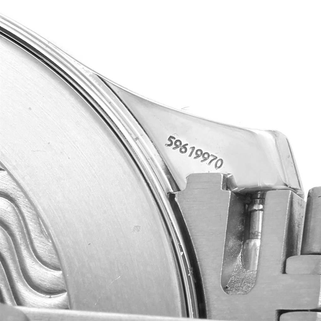 The image shows a partial close-up of the case back and a portion of the bracelet attachment of an Omega Seamaster 2541.80.00 Men
s Stainless Steel Blue Dial 2541.80.00 Men
s Stainless Steel Blue Dial watch.