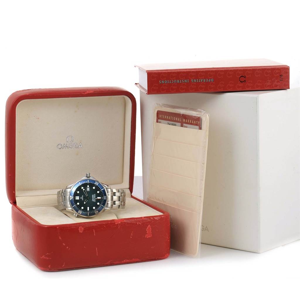 The Omega Seamaster 2541.80.00 Men's Stainless Steel Blue Dial 2541.80.00 Men's Stainless Steel Blue Dial watch is shown from a frontal angle in its open red box, alongside the warranty and operating instructions.