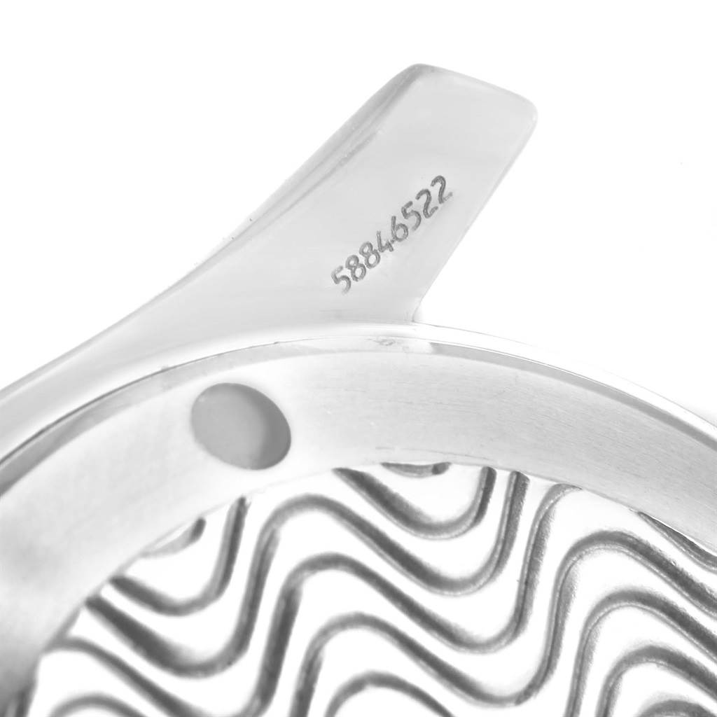 The image shows a close-up of the Omega Seamaster 2561.80.00 Men
s Stainless Steel Blue Dial 2561.80.00 Men
s Stainless Steel Blue Dial
s case, focusing on the serial number and wavy dial pattern.