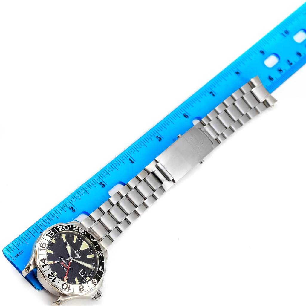 The image shows an Omega Seamaster 2534.50.00 Men
s Stainless Steel Black Dial 2534.50.00 Men
s Stainless Steel Black Dial watch with its strap fully extended next to a blue ruler for size comparison.