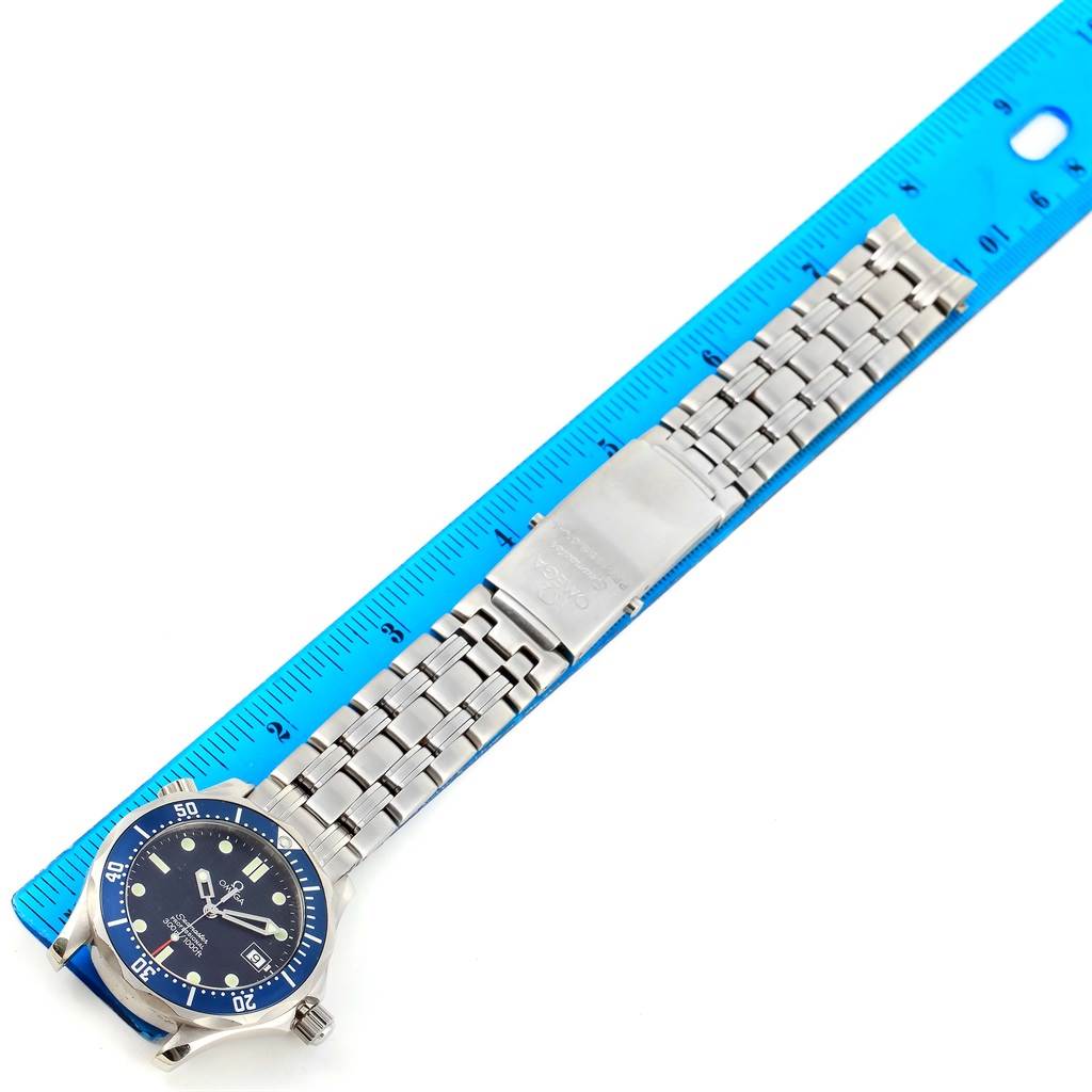 The Omega Seamaster 2561.80.00 Men
s Stainless Steel Blue Dial 2561.80.00 Men
s Stainless Steel Blue Dial watch is shown from a top-down angle with an extended metal bracelet and a ruler for scale.