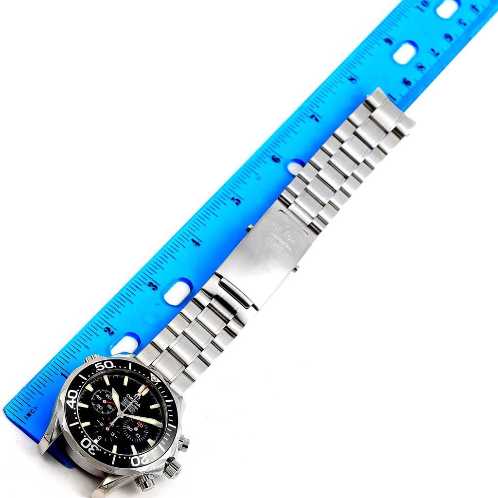 The image shows an Omega Seamaster 2594.52.00 Men
s Stainless Steel Black Dial 2594.52.00 Men
s Stainless Steel Black Dial watch laid flat with a stainless steel bracelet, positioned next to a blue ruler for measurement.