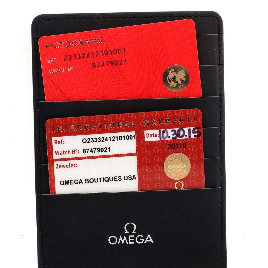 The image shows two Omega cards—Pictograms and International Warranty—in a black holder for the Seamaster model.