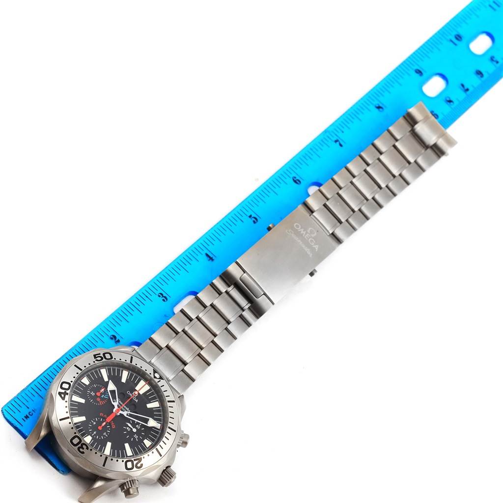 The image shows an Omega Seamaster 2269.52.00 Men's Titanium Black Dial 2269.52.00 Men's Titanium Black Dial watch face and bracelet next to a blue ruler, viewed from above.