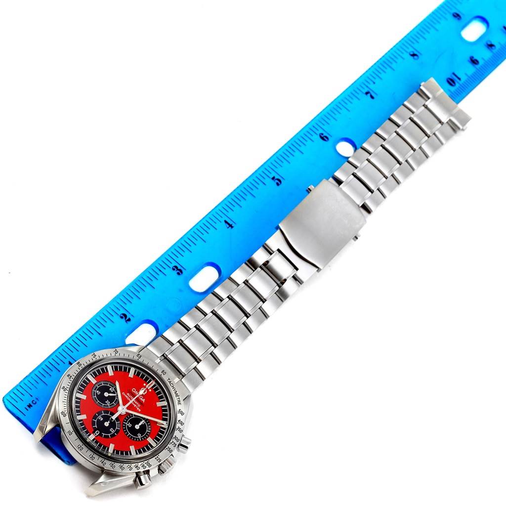 The image shows an Omega Seamaster 3506.61.00 Men's Stainless Steel Red Dial 3506.61.00 Men's Stainless Steel Red Dial watch, including the face, bezel, and metal bracelet placed alongside a ruler.