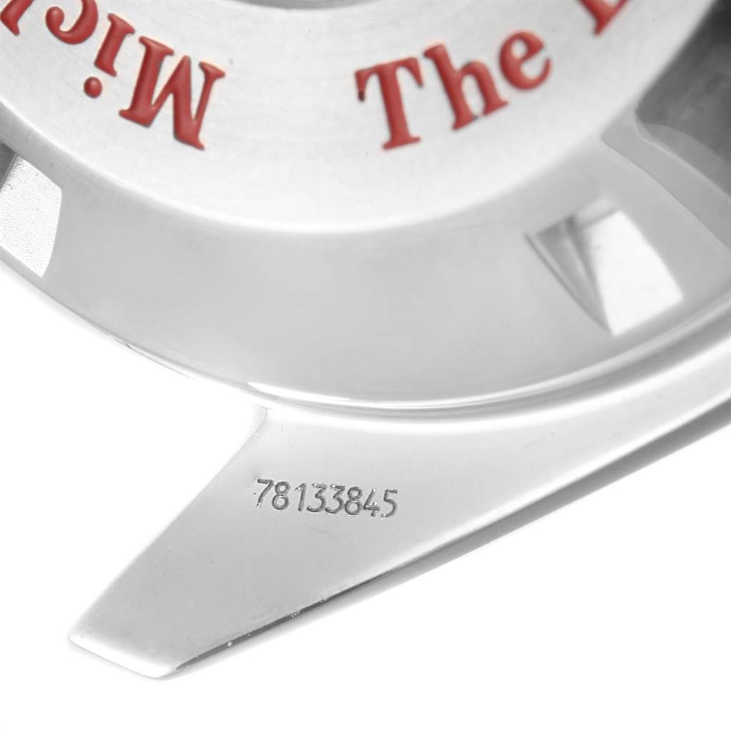 The image shows a close-up of the case back of an Omega Seamaster 3506.61.00 Men's Stainless Steel Red Dial 3506.61.00 Men's Stainless Steel Red Dial watch with visible text and a serial number engraved.