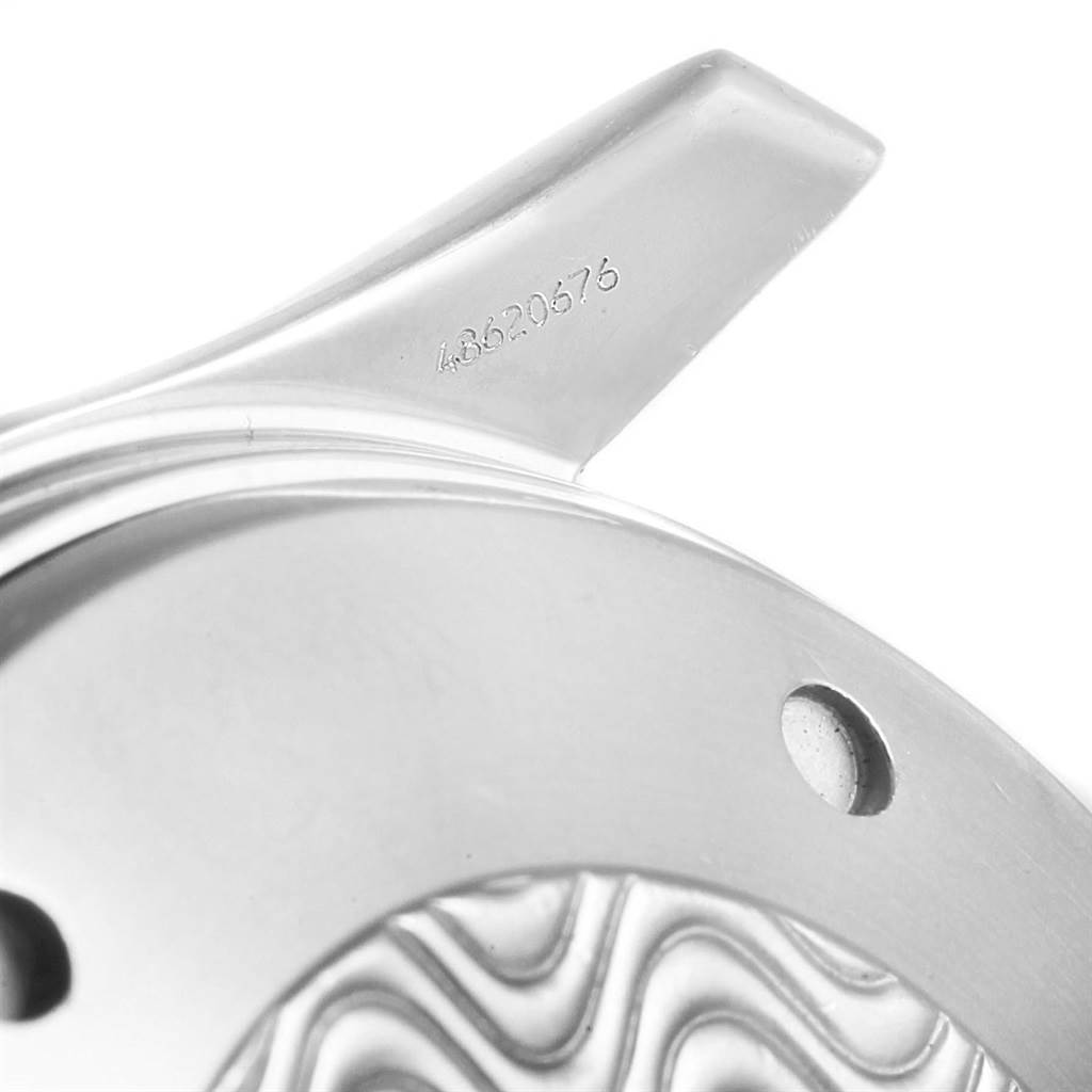 Close-up of the Omega Seamaster 2598.80.00 Men
s Stainless Steel Blue Dial 2598.80.00 Men
s Stainless Steel Blue Dial watch case
s edge, serial number, and part of the wave-patterned back.