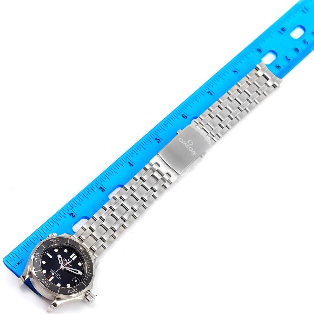 The image displays an Omega Seamaster 212.30.36.20.01.002 Men
s Stainless Steel Black Dial 212.30.36.20.01.002 Men
s Stainless Steel Black Dial watch laid flat next to a ruler, showing the face, bezel, and metal bracelet with the Omega logo.