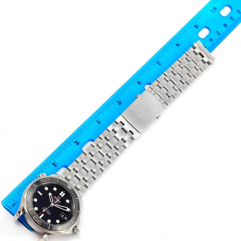 The image shows an Omega Seamaster 212.30.41.20.01.003 Men
s Stainless Steel Black Dial 212.30.41.20.01.003 Men
s Stainless Steel Black Dial watch laid flat with a blue ruler next to it for scale, displaying the face, bezel, and bracelet.