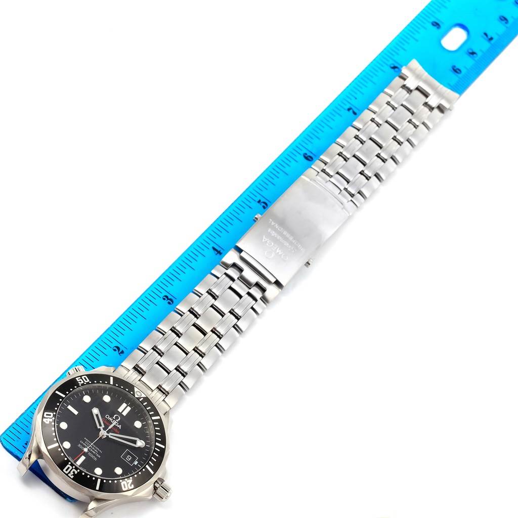 The image shows the Omega Seamaster 212.30.41.20.01.002 Men
s Stainless Steel Black Dial 212.30.41.20.01.002 Men
s Stainless Steel Black Dial watch laid flat with its face and metal bracelet visible, next to a blue ruler.