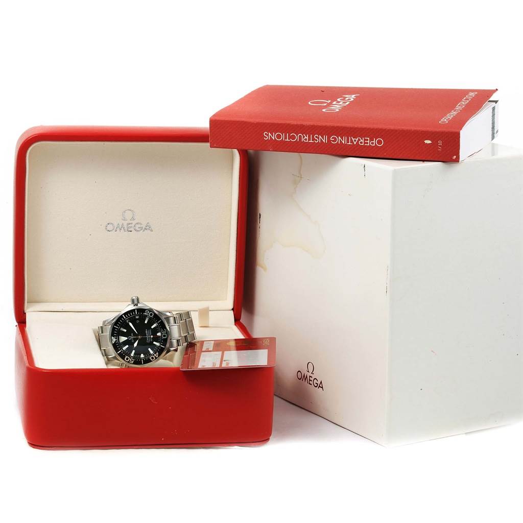 The Omega Seamaster 2262.50.00 Men
s Stainless Steel Black Dial 2262.50.00 Men
s Stainless Steel Black Dial watch is shown inside its red box, accompanied by an operating instructions manual.