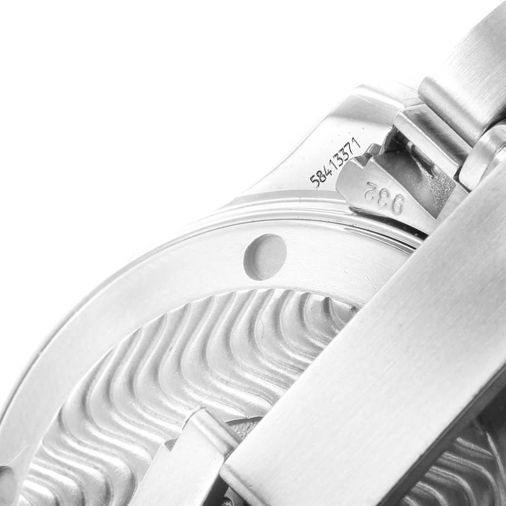 This image shows a close-up of the Omega Seamaster 2262.50.00 Men
s Stainless Steel Black Dial 2262.50.00 Men
s Stainless Steel Black Dial
s case back and bracelet links from an angle highlighting the serial number and wave pattern.