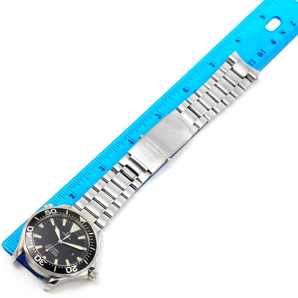 The image shows an Omega Seamaster 2264.50.00 Men
s Stainless Steel Black Dial 2264.50.00 Men
s Stainless Steel Black Dial watch featuring the face, bezel, and stainless steel bracelet, placed next to a blue ruler.