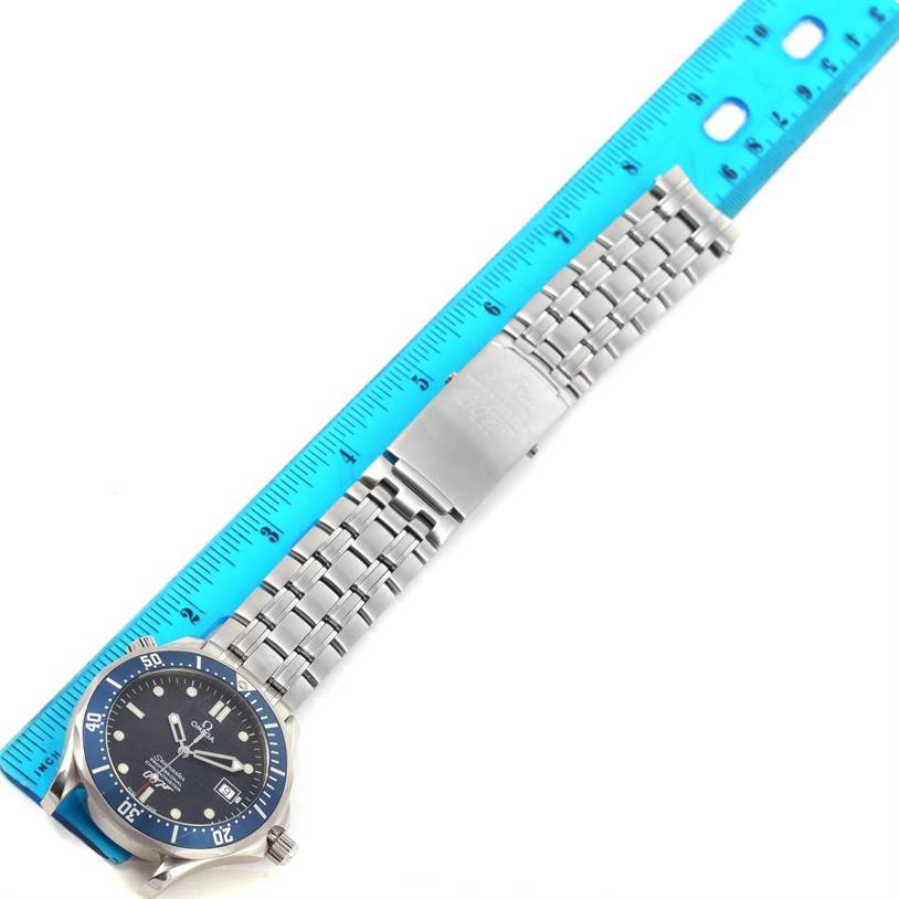 The image shows an overhead view of the Omega Seamaster 2537.80.00 Men's Stainless Steel Blue Dial 2537.80.00 Men's Stainless Steel Blue Dial watch, displaying its blue dial, bezel, and metal bracelet next to a ruler.