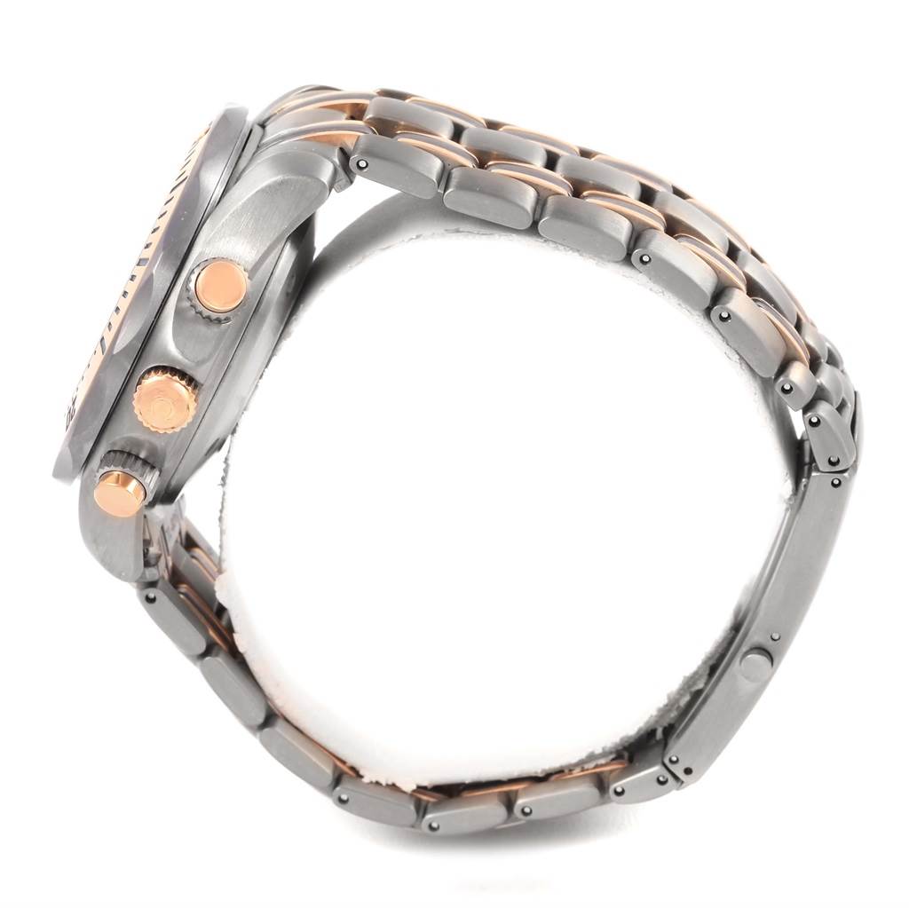 The image shows a side view of an Omega Seamaster 2296.80.00 Titanium Blue Dial 2296.80.00 Titanium Blue Dial watch, highlighting its crown, pushers, and two-tone metal bracelet.