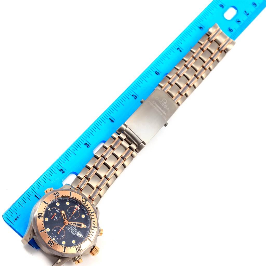 The Omega Seamaster 2296.80.00 Titanium Blue Dial 2296.80.00 Titanium Blue Dial watch is shown from a top-down angle, featuring the face and entire metal bracelet with a blue ruler beside it.