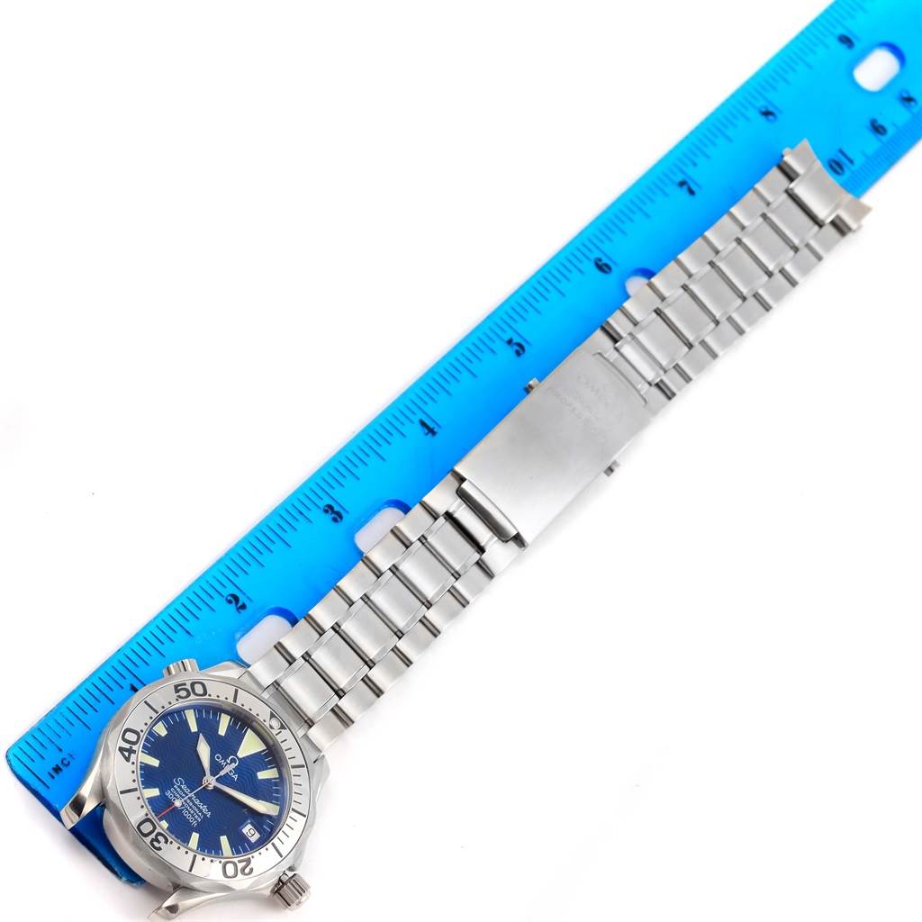 The Omega Seamaster 2554.80.00 Men
s Stainless Steel Blue Dial 2554.80.00 Men
s Stainless Steel Blue Dial watch is shown horizontally with a focus on its blue dial and metal bracelet, next to a blue ruler for measurement.