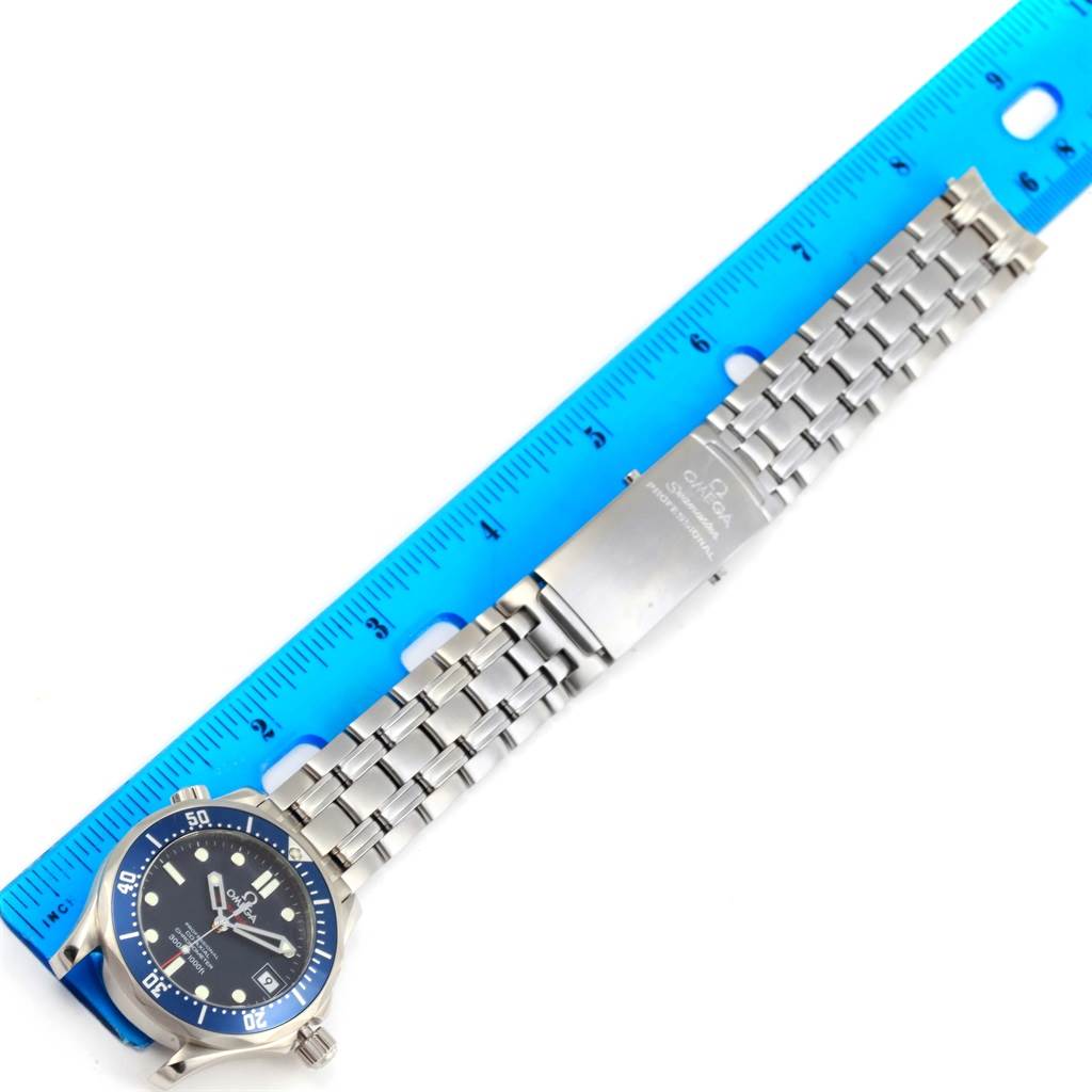 The Omega Seamaster 2222.80.00 Men's Stainless Steel Blue Dial 2222.80.00 Men's Stainless Steel Blue Dial watch is shown laid flat with the face, bezel, and metal bracelet visible, alongside a ruler for scale.