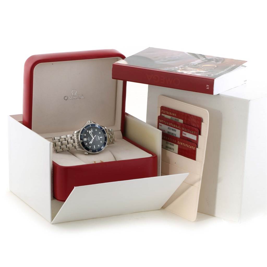 The image shows an Omega Seamaster 2537.80.00 Men's Stainless Steel Blue Dial 2537.80.00 Men's Stainless Steel Blue Dial watch in its open box with warranty cards and a booklet beside it.