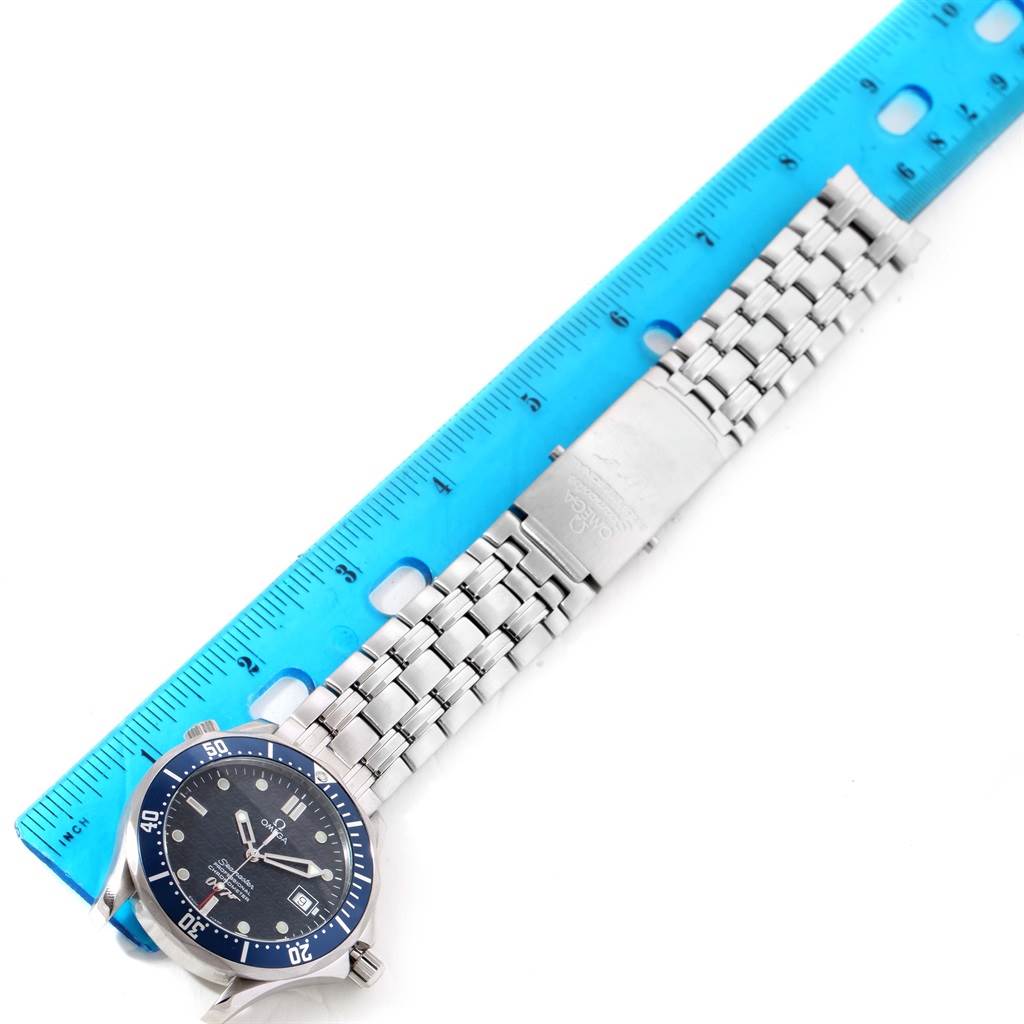 The image shows an Omega Seamaster 2537.80.00 Men's Stainless Steel Blue Dial 2537.80.00 Men's Stainless Steel Blue Dial watch laid flat with the face partially visible next to a blue ruler for scale.