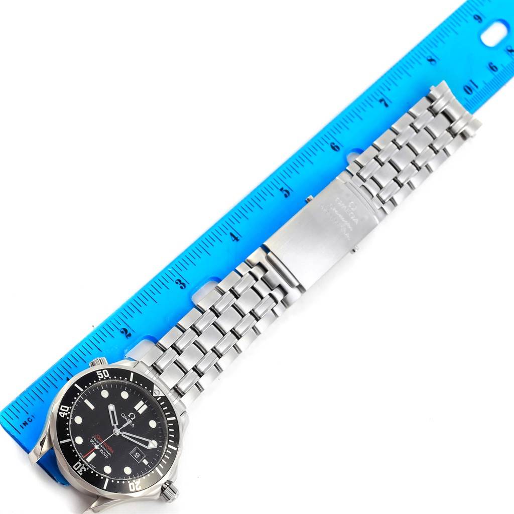 The image shows the Omega Seamaster 212.30.41.61.01.001 Men
s Stainless Steel Black Dial 212.30.41.61.01.001 Men
s Stainless Steel Black Dial watch laid flat with its metal bracelet against a ruler for measurement.