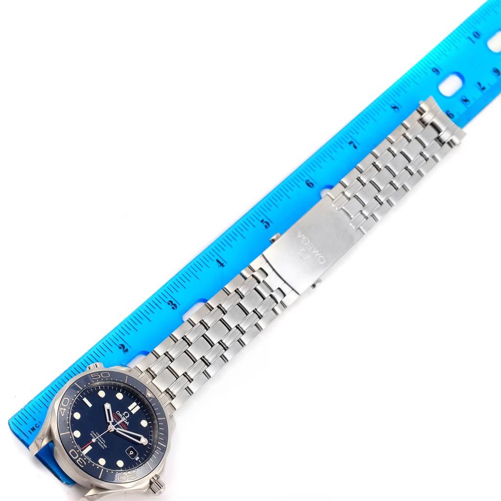 This image shows an Omega Seamaster 212.30.41.20.03.001 Men
s Stainless Steel Blue Dial 212.30.41.20.03.001 Men
s Stainless Steel Blue Dial watch laid flat alongside a ruler, highlighting its face, bezel, and metal bracelet.