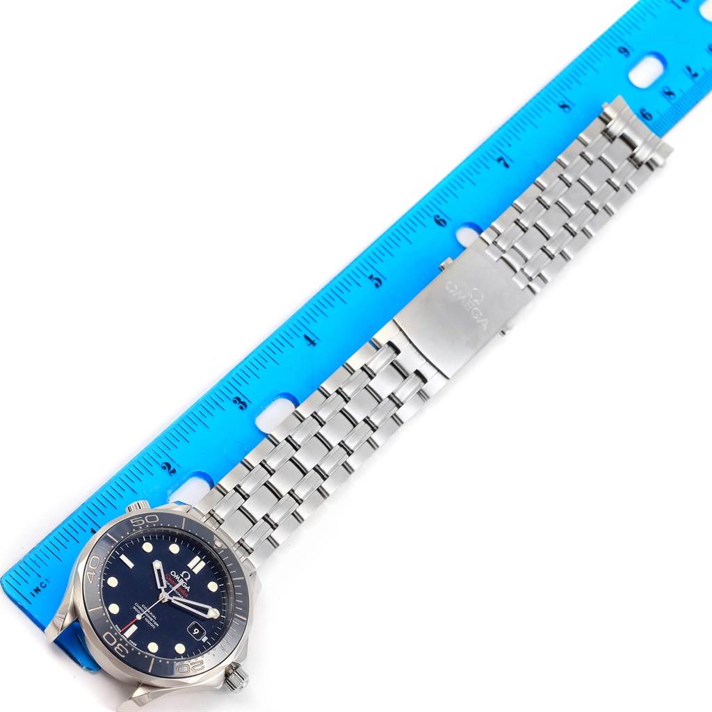 The image shows an Omega Seamaster 212.30.41.20.03.001 Men
s Stainless Steel Blue Dial 212.30.41.20.03.001 Men
s Stainless Steel Blue Dial watch laid flat, with its face, bezel, and stainless steel bracelet visible next to a blue ruler.