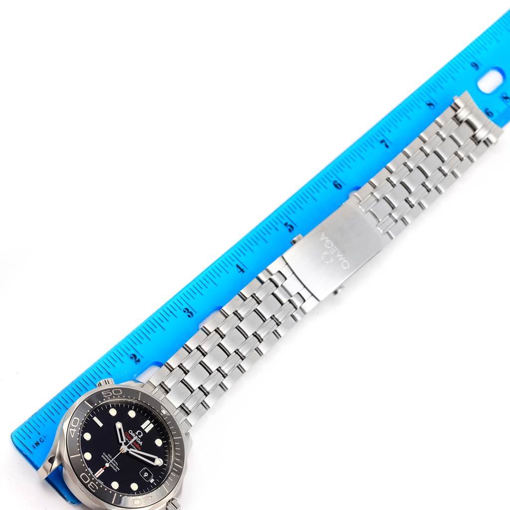 The image shows a side view of an Omega Seamaster 212.30.41.20.01.003 Men
s Stainless Steel Black Dial 212.30.41.20.01.003 Men
s Stainless Steel Black Dial watch focusing on the dial, bezel, and metal bracelet next to a ruler.