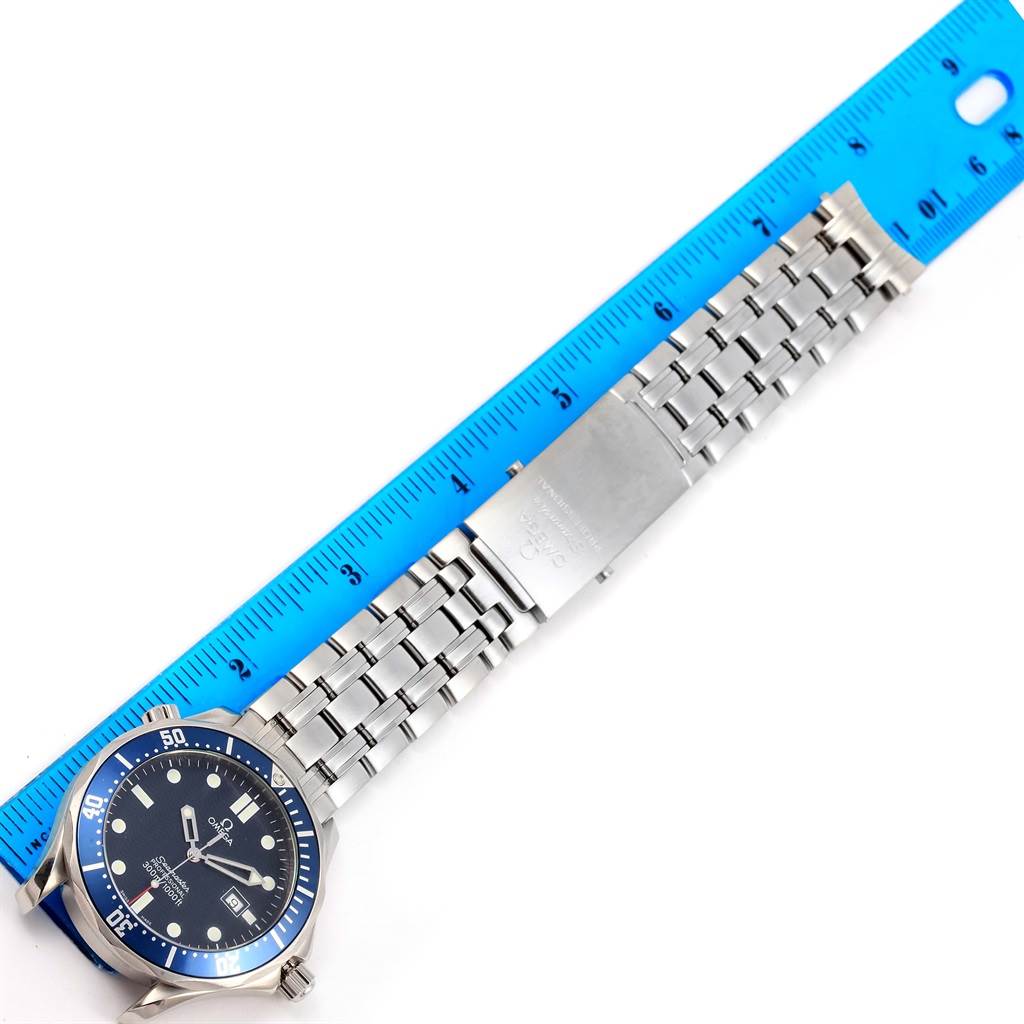 The Omega Seamaster 2541.80.00 Men
s Stainless Steel Blue Dial 2541.80.00 Men
s Stainless Steel Blue Dial watch is shown flat with its face and metal bracelet displayed alongside a blue ruler for scale.