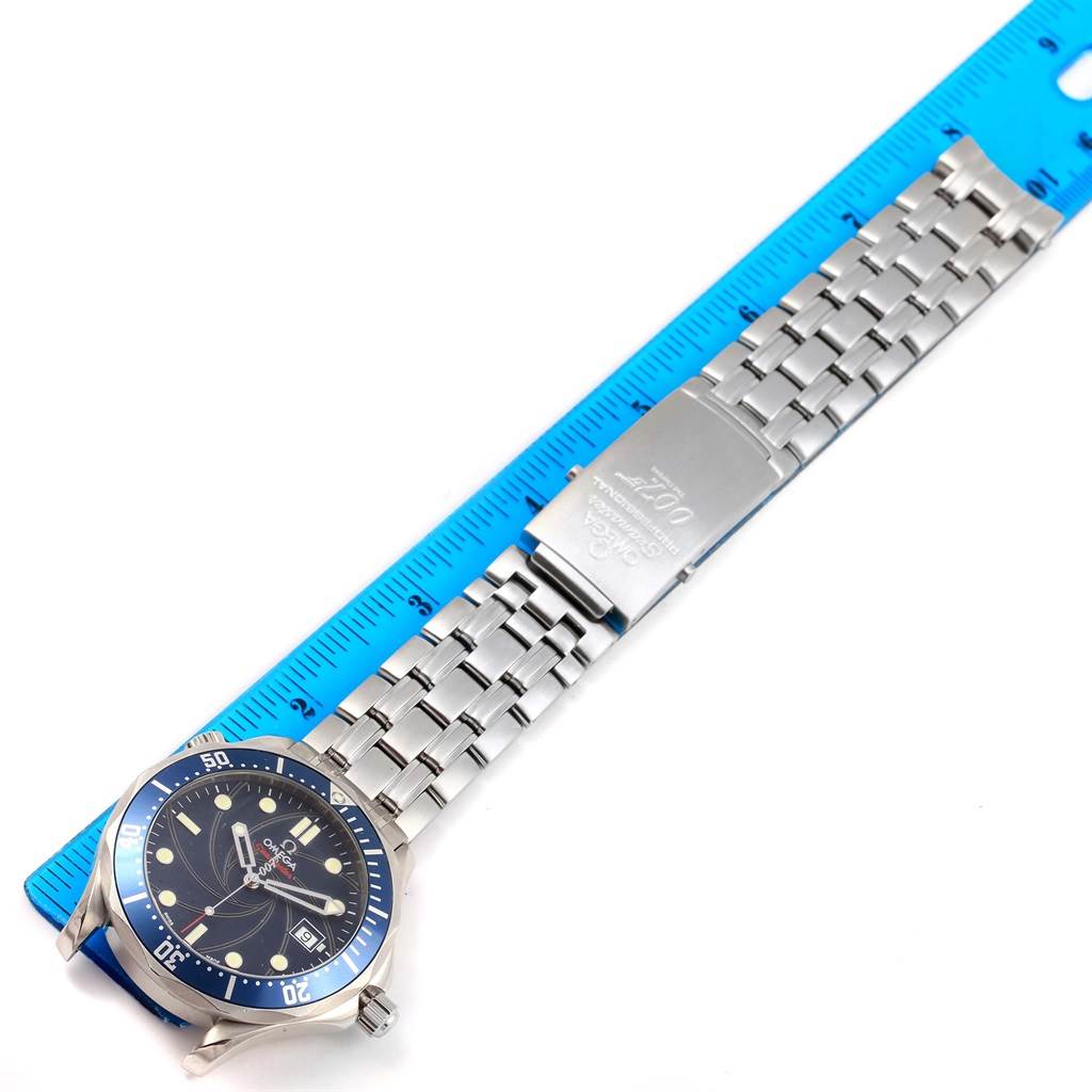 The image shows a top-down view of the Omega Seamaster 2226.80.00 Men
s Stainless Steel Blue Dial 2226.80.00 Men
s Stainless Steel Blue Dial watch with its face, metal bracelet, and clasp extended next to a ruler.