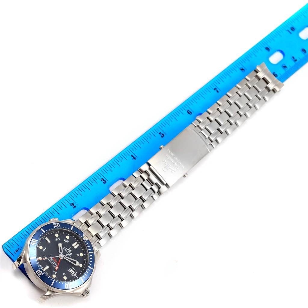 The image shows an Omega Seamaster 2535.80.00 Men
s Stainless Steel Blue Dial 2535.80.00 Men
s Stainless Steel Blue Dial watch laid flat alongside a blue ruler, displaying its face and metal bracelet.