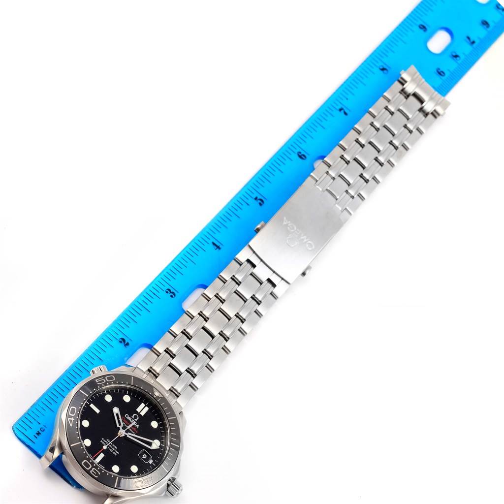 The Omega Seamaster 212.30.41.20.01.003 Men
s Stainless Steel Black Dial 212.30.41.20.01.003 Men
s Stainless Steel Black Dial watch is shown from a top-down angle with the bracelet laid out next to a blue ruler for scale.