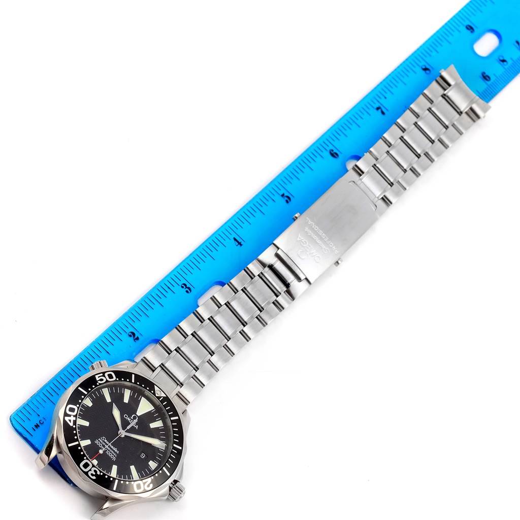 The image shows a top-down view of an Omega Seamaster 2264.50.00 Men
s Stainless Steel Black Dial 2264.50.00 Men
s Stainless Steel Black Dial watch and its stainless steel bracelet measured against a ruler.