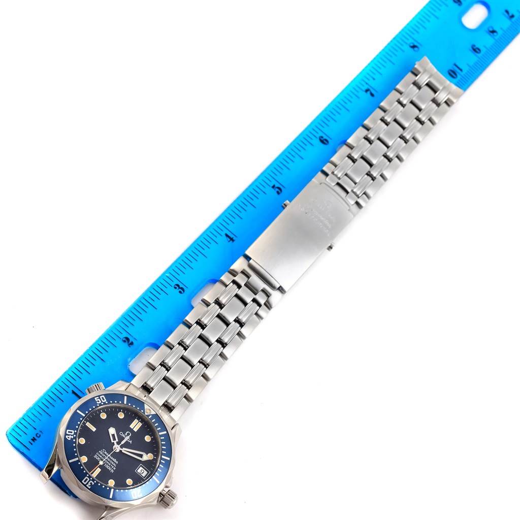The Omega Seamaster 2551.80.00 Men
s Stainless Steel Blue Dial 2551.80.00 Men
s Stainless Steel Blue Dial watch is displayed flat with a blue ruler measuring its stainless steel bracelet and clasp.