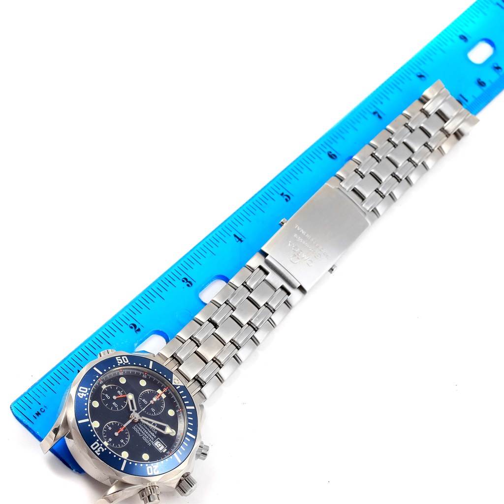 The image shows an Omega Seamaster 2599.80.00 Men
s Stainless Steel Blue Dial 2599.80.00 Men
s Stainless Steel Blue Dial watch laid flat next to a blue ruler, displaying the bracelet and dial from a top-down angle.