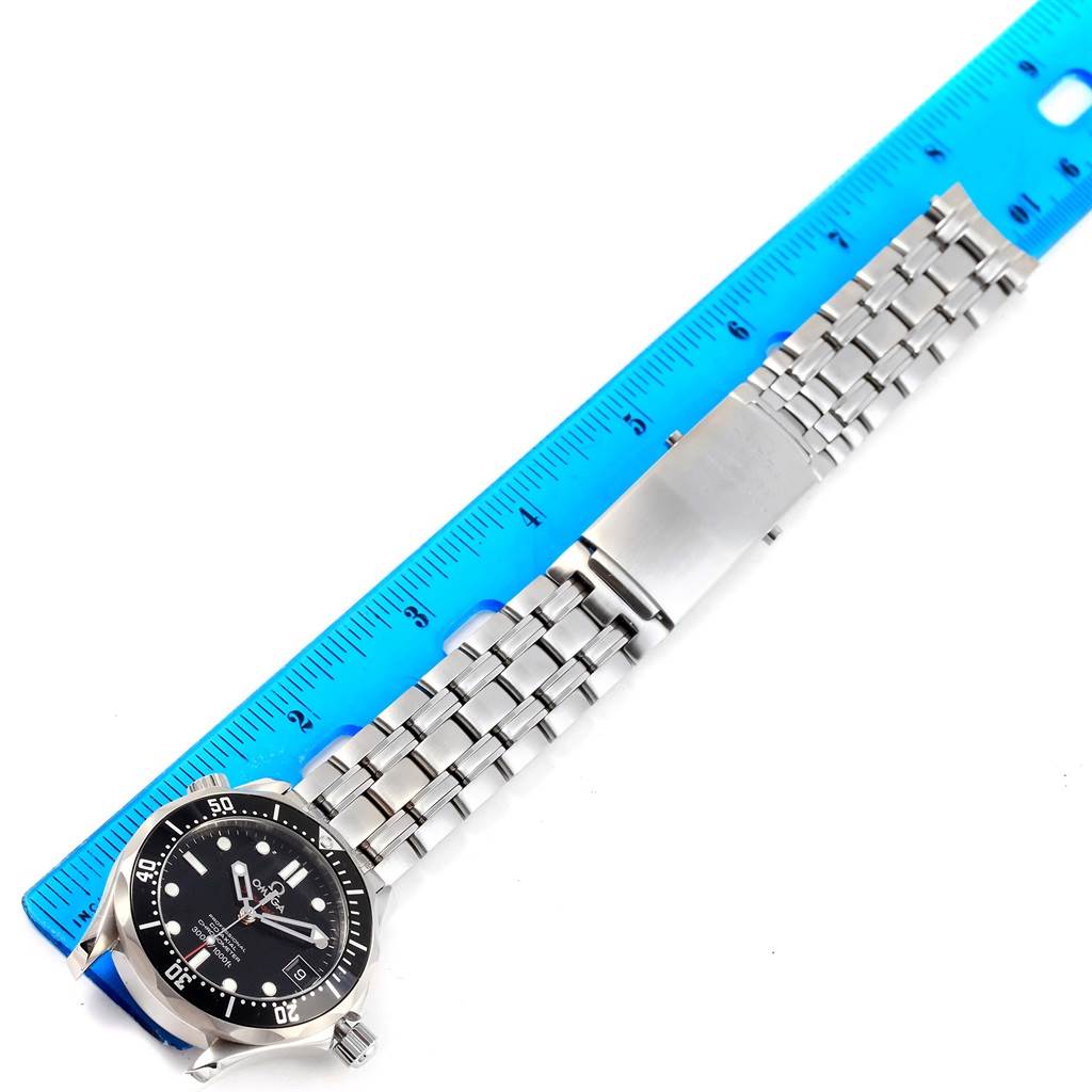 The Omega Seamaster 212.30.36.20.01.001 Men
s Stainless Steel Black Dial 212.30.36.20.01.001 Men
s Stainless Steel Black Dial watch is shown flat and horizontally with its stainless steel bracelet alongside a ruler for scale.