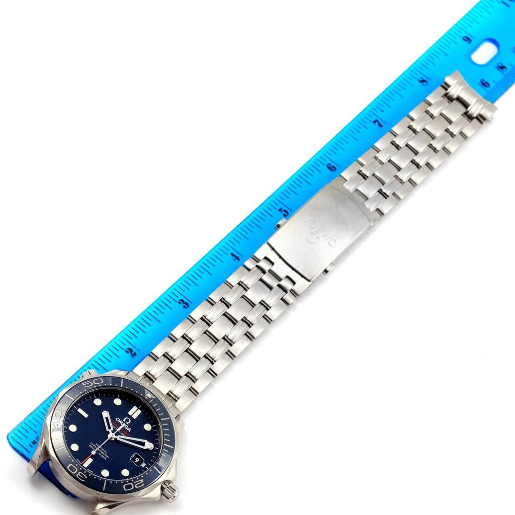 The Omega Seamaster 212.30.41.20.03.001 Men
s Stainless Steel Blue Dial 212.30.41.20.03.001 Men
s Stainless Steel Blue Dial watch is shown from an overhead angle, featuring its face, bracelet, and clasp alongside a measuring ruler.