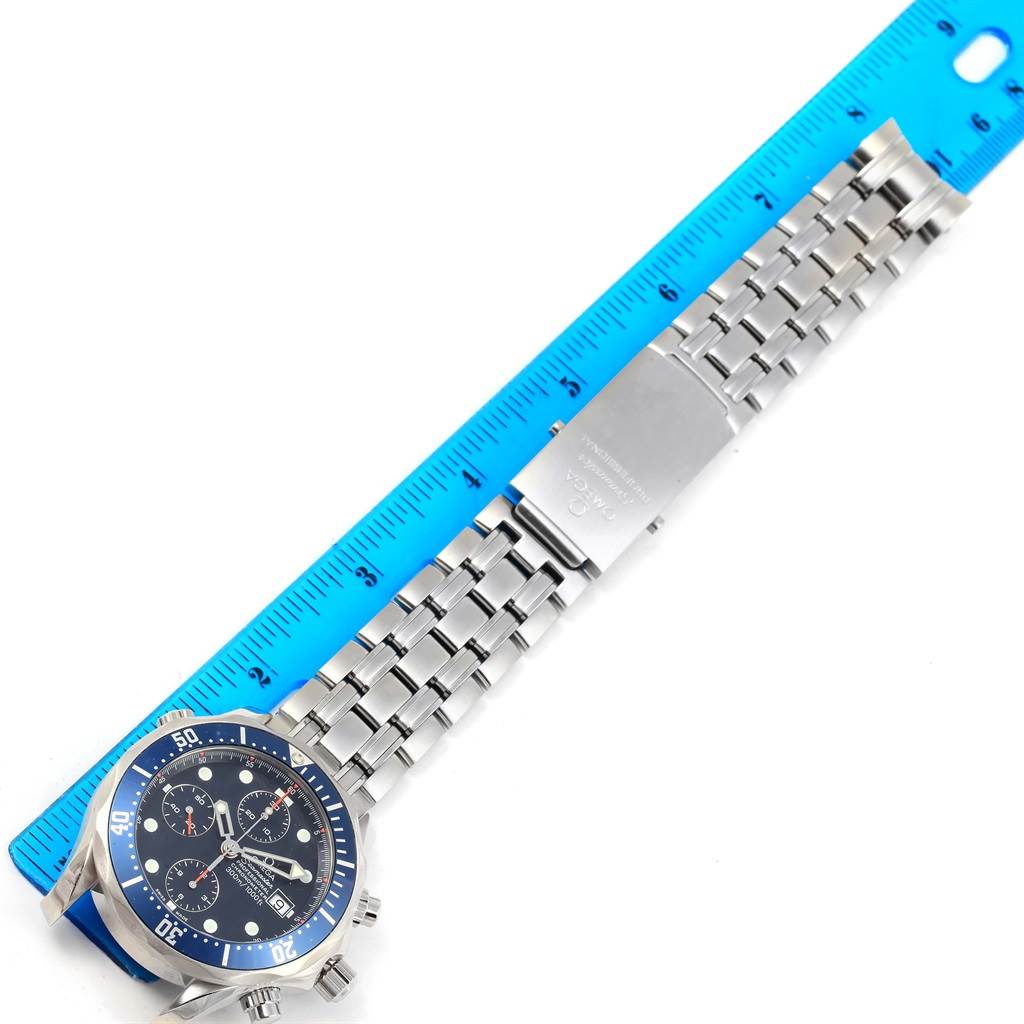 The Omega Seamaster 2599.80.00 Men
s Stainless Steel Blue Dial 2599.80.00 Men
s Stainless Steel Blue Dial watch is displayed flat with a focus on its face, bracelet, and clasp alongside a ruler for scale.